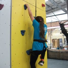 Girl on a climbing wall