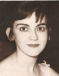 Black and white photo of a young white woman with dark hair and a pixie cut.