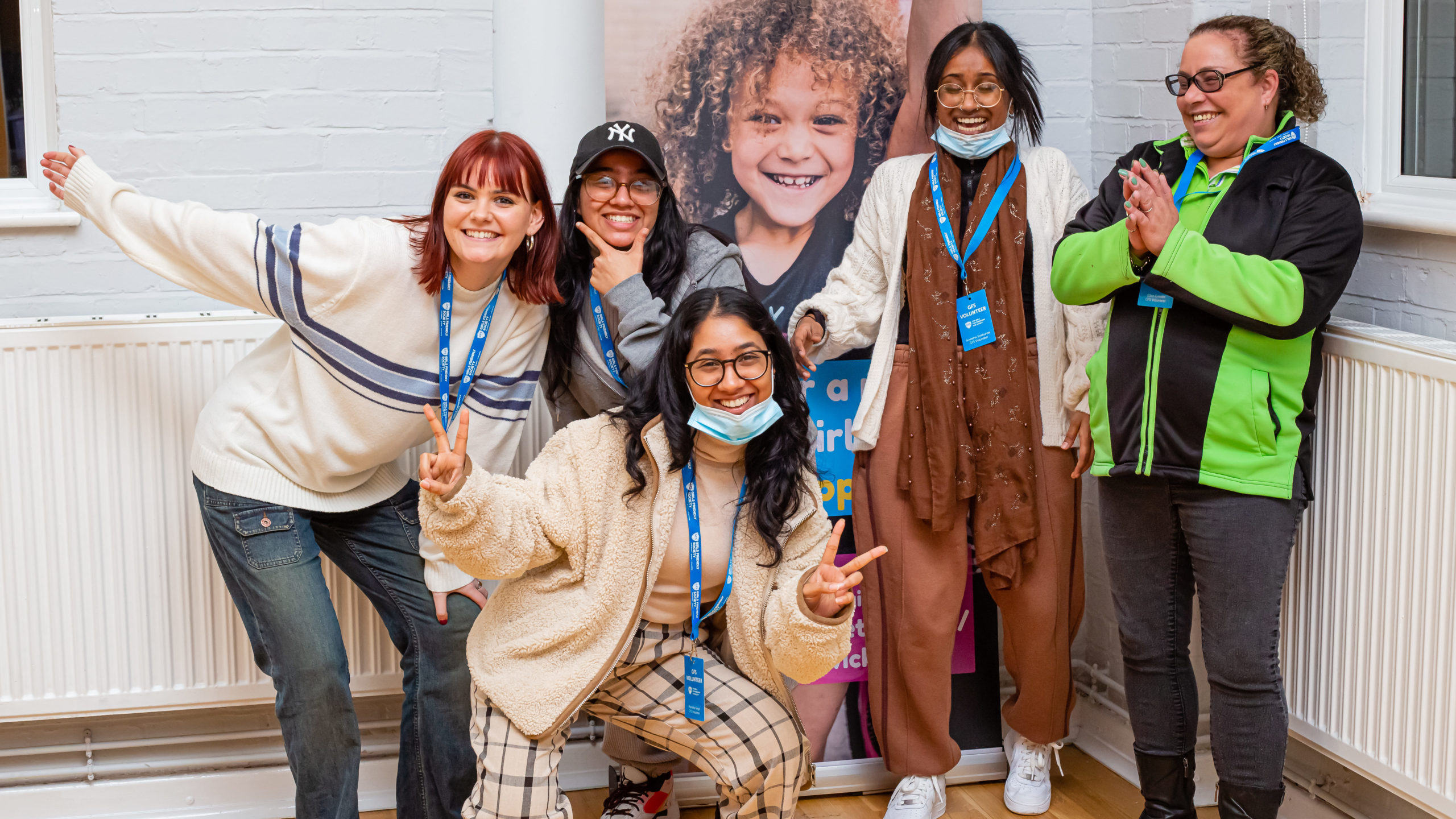 five volunteers smiling and posing at a GFS session