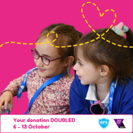 Two young girls in bright clothing and wearing ponytails look off camera to the left. They are on a pink background. Text reads: Your donation doubled, 6-13 October